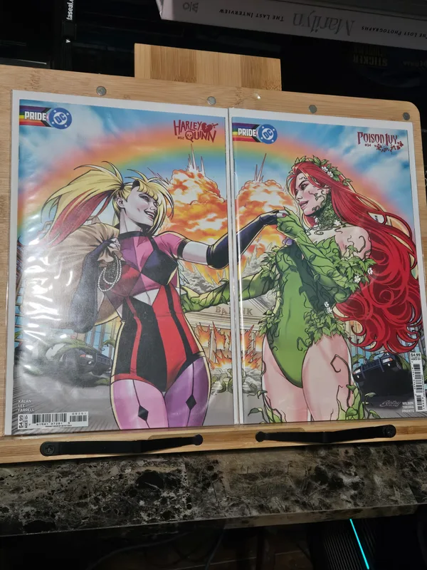 Connecting DC Pride variant covers for Poison Ivy #23 and Harley Quinn #41, featuring artwork of the iconic duo together.