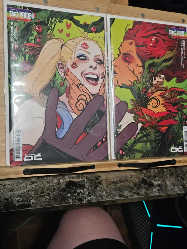 Harley Quinn #31 and Poison Ivy #13 Dawn of DC Pride variant covers displayed side-by-side to reveal the connecting artwork featuring Harley Quinn and Poison Ivy