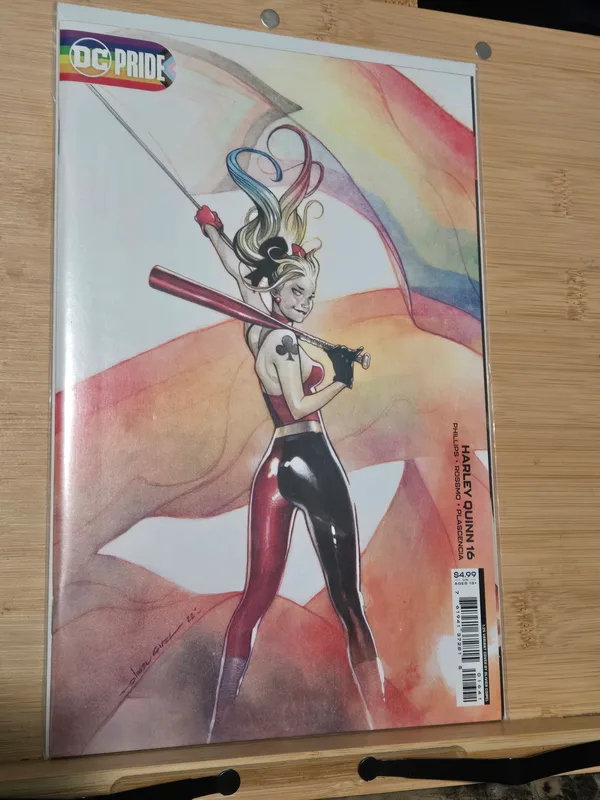 Harley Quinn #16 DC Pride 1:25 variant cover by artist Olivier Coipel, featuring a dynamic illustration of Harley Quinn with a pride flag.
