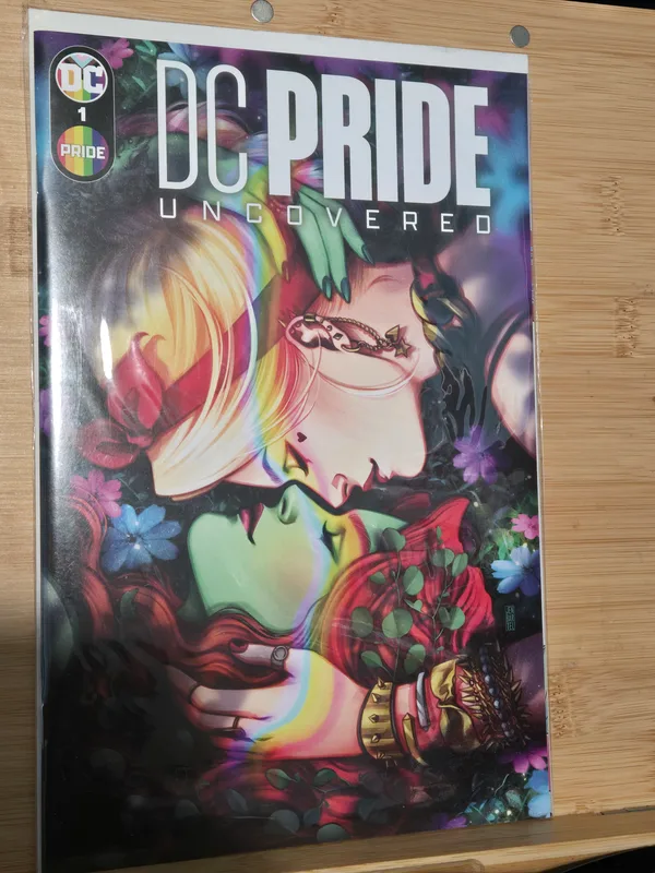 DC Pride: Uncovered #1 comic book featuring cover art by Jen Bartel, showcasing a romantic illustration of Harley Quinn and Poison Ivy
